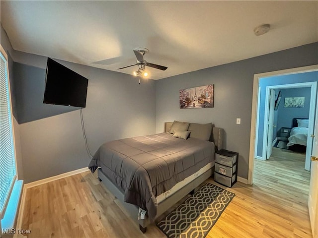 bedroom with light hardwood / wood-style flooring and ceiling fan