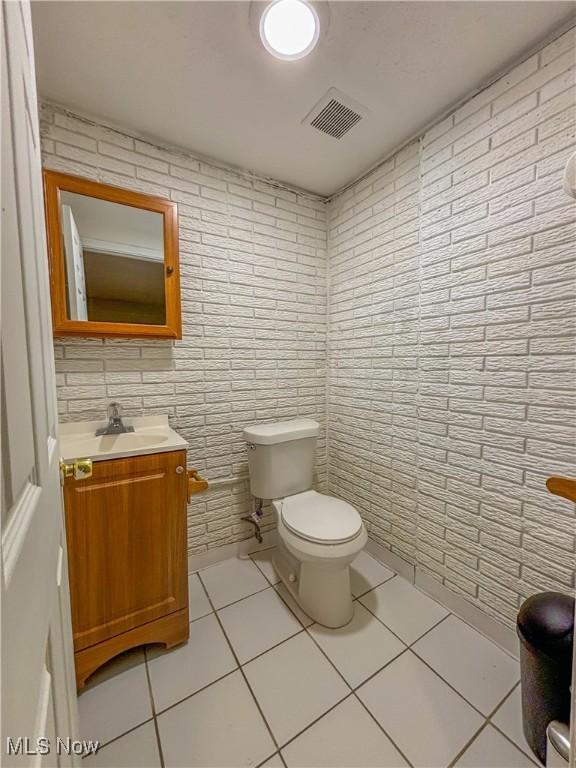 bathroom with vanity, toilet, and tile patterned flooring