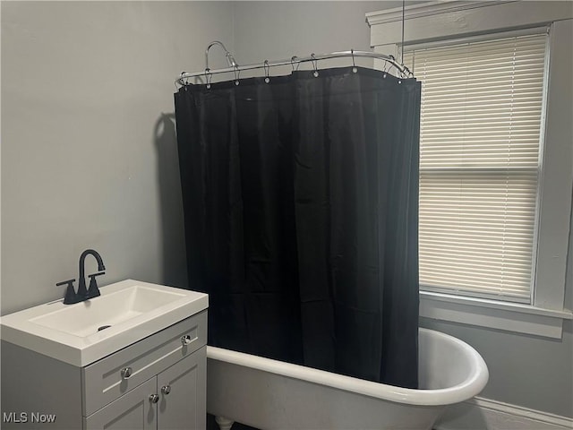 bathroom featuring vanity and shower / bathtub combination with curtain