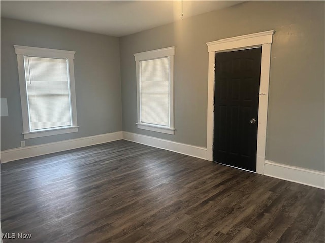 spare room with dark hardwood / wood-style floors