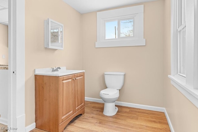 bathroom featuring vanity, hardwood / wood-style flooring, and toilet