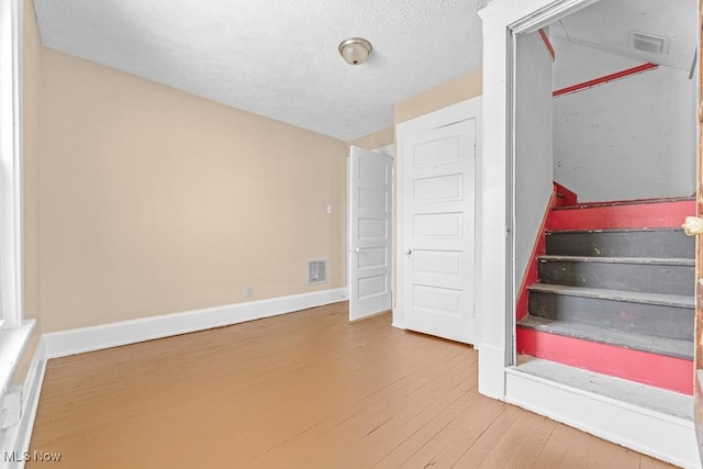 staircase with hardwood / wood-style floors