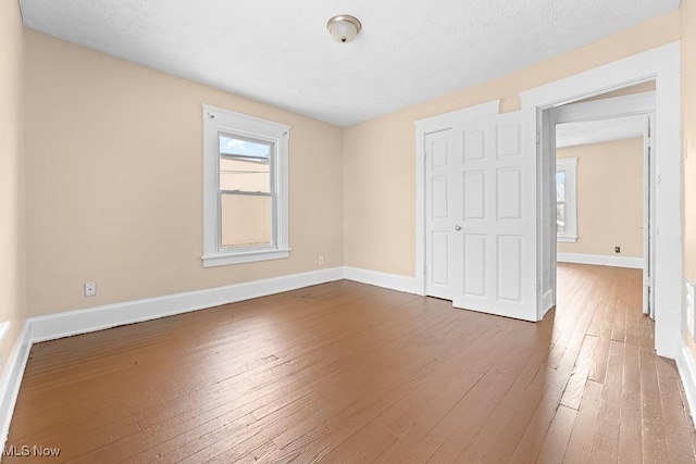 unfurnished bedroom featuring hardwood / wood-style flooring and a closet