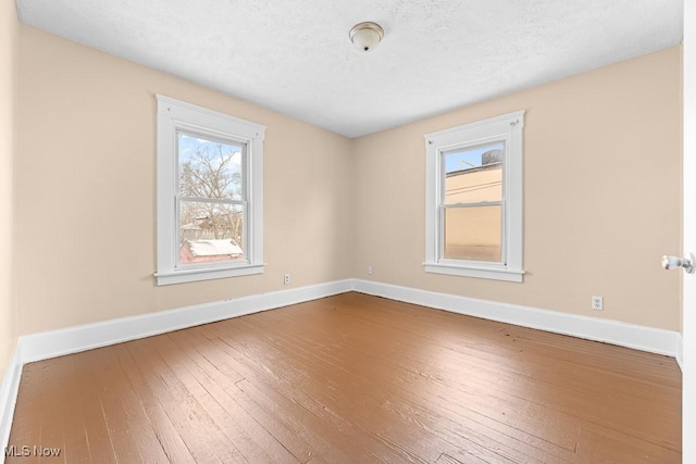 empty room featuring hardwood / wood-style floors and a textured ceiling