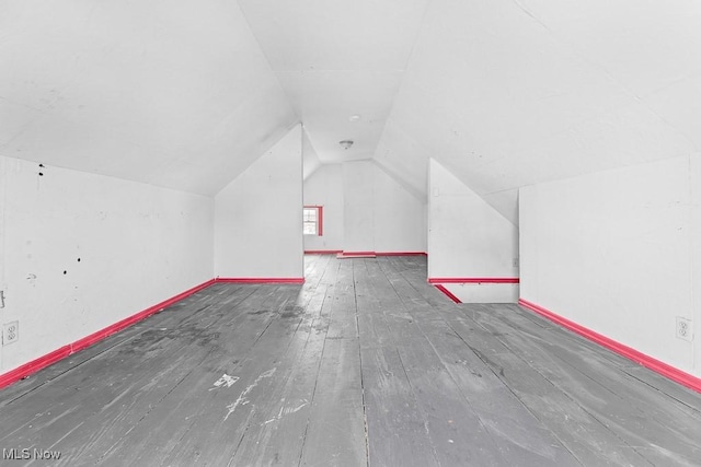 bonus room with wood-type flooring and lofted ceiling