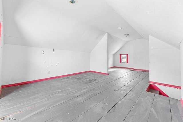 bonus room featuring hardwood / wood-style flooring and vaulted ceiling