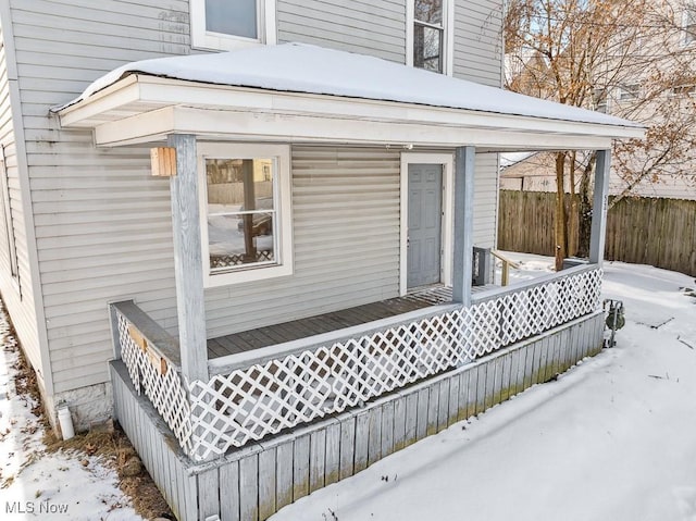 view of snowy exterior with a porch