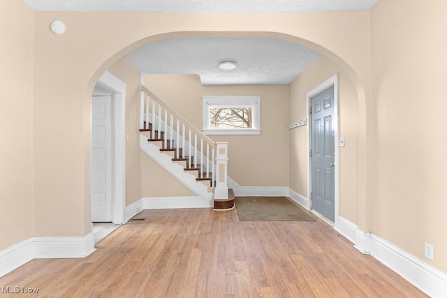 entryway featuring light hardwood / wood-style floors and a textured ceiling