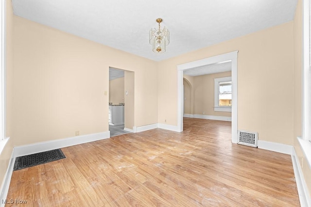 interior space featuring a notable chandelier and light hardwood / wood-style flooring