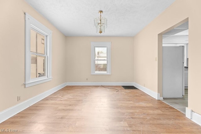 interior space featuring a textured ceiling and light hardwood / wood-style floors