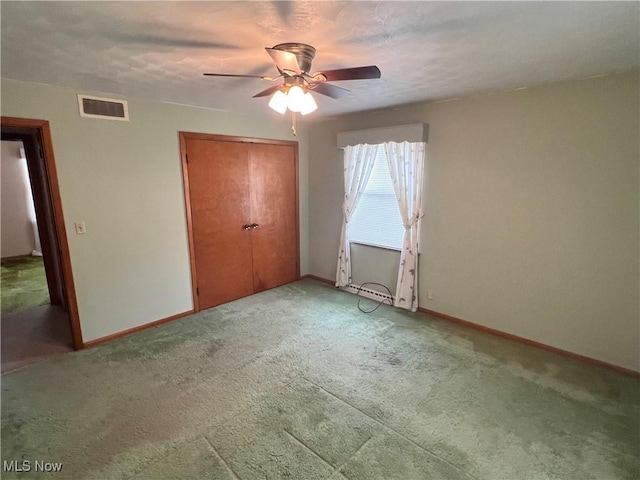 unfurnished bedroom featuring a closet, ceiling fan, and carpet