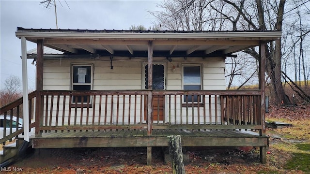 rear view of property with covered porch