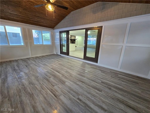 spare room featuring lofted ceiling, wood-type flooring, wooden ceiling, and ceiling fan