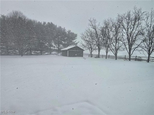 yard layered in snow featuring an outbuilding