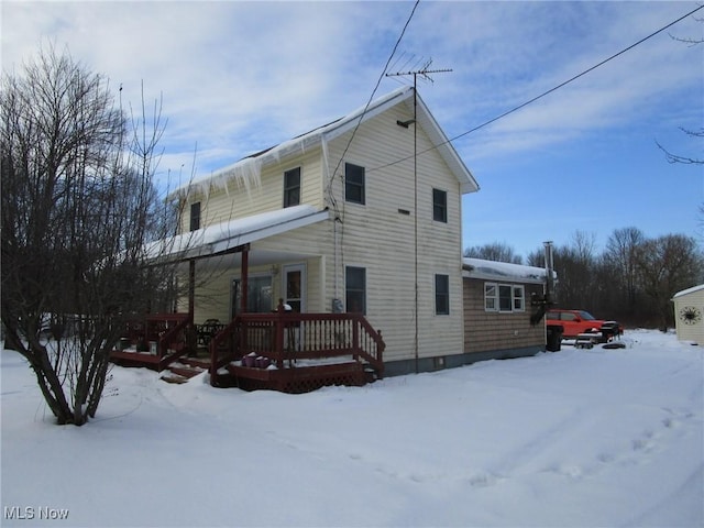 snow covered property featuring a porch