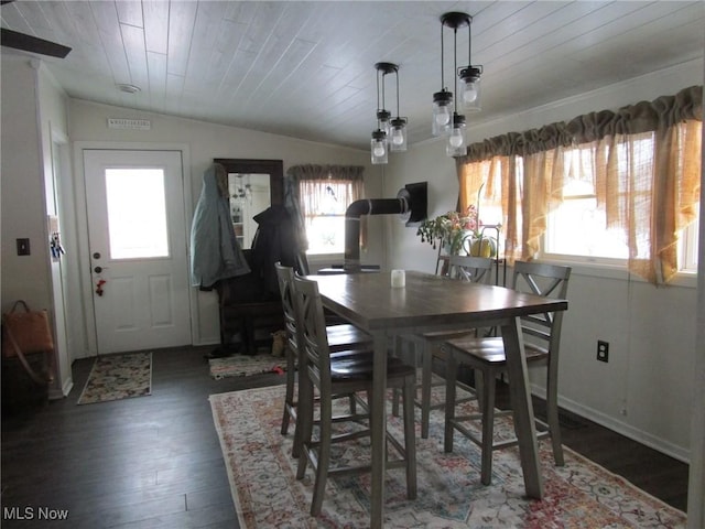 dining space with vaulted ceiling, dark wood-type flooring, a wealth of natural light, and wooden ceiling