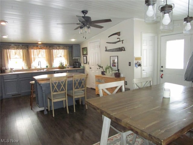 dining room featuring lofted ceiling, sink, wood ceiling, dark wood-type flooring, and ceiling fan