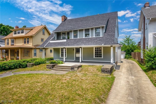 view of front facade with a front yard and a porch