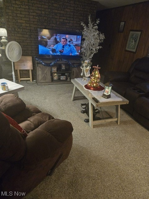 carpeted living room with wooden walls