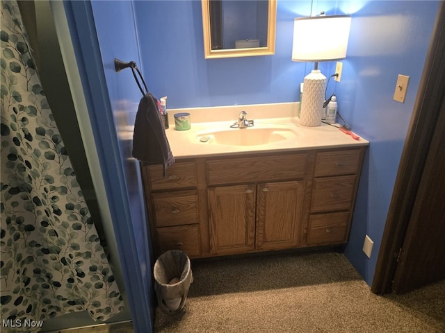 bathroom featuring vanity and curtained shower