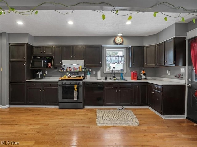 kitchen with dark brown cabinets, sink, light wood-type flooring, and black appliances