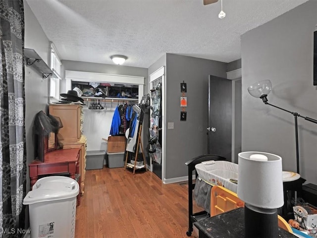 bathroom featuring hardwood / wood-style floors and a textured ceiling