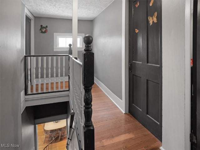 interior space featuring hardwood / wood-style flooring and a textured ceiling