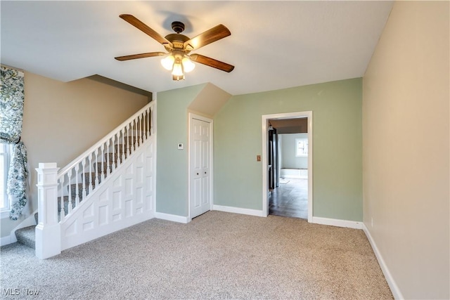 unfurnished room featuring carpet floors and ceiling fan