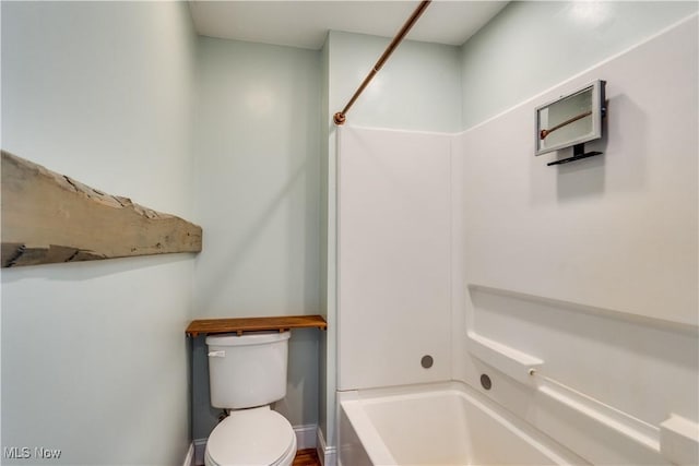 bathroom featuring toilet and bathing tub / shower combination