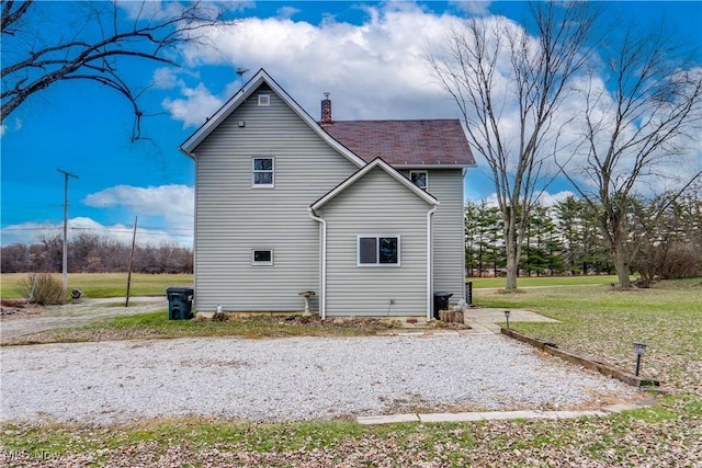 view of property exterior with a lawn