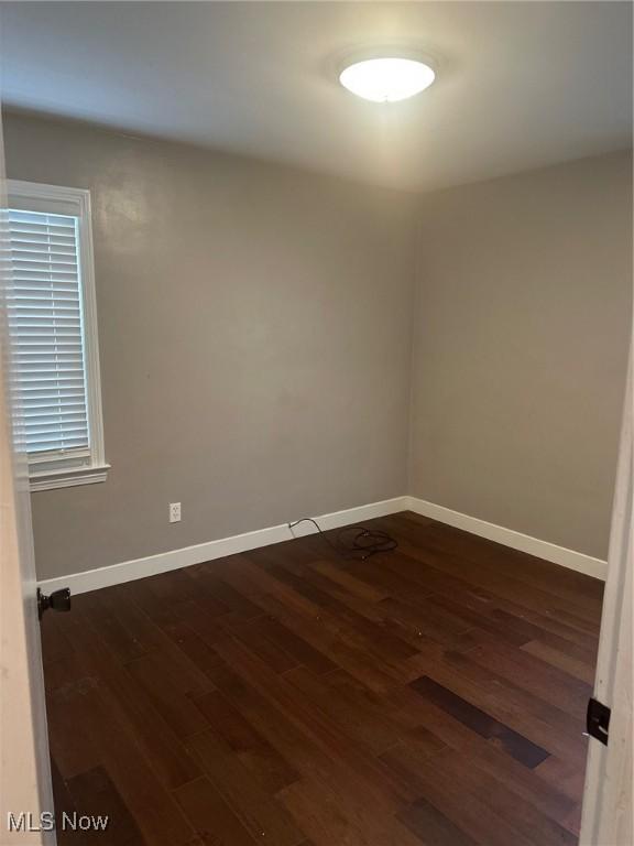 empty room featuring dark hardwood / wood-style flooring