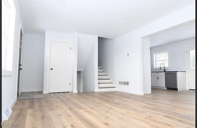 unfurnished living room featuring light wood-type flooring