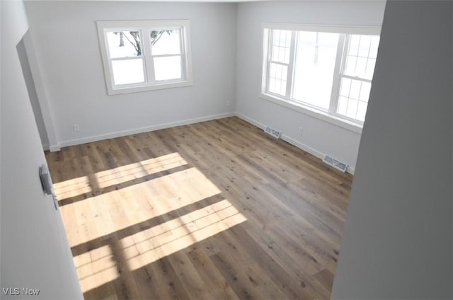 unfurnished room featuring hardwood / wood-style floors