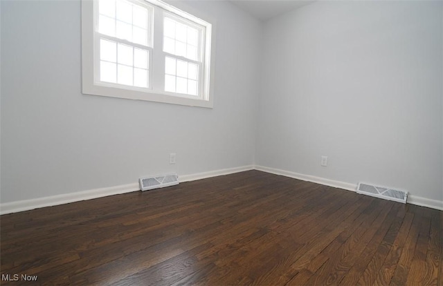 empty room with dark hardwood / wood-style floors