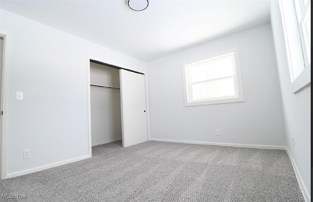 unfurnished bedroom featuring a closet and carpet