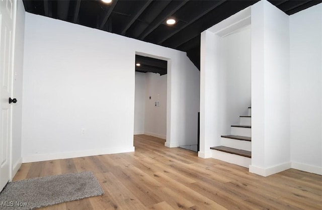 basement with hardwood / wood-style flooring