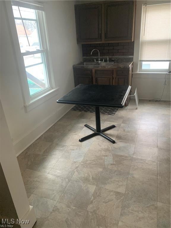 unfurnished dining area with sink and a wealth of natural light