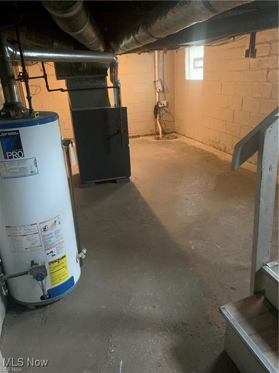 basement featuring heating unit and gas water heater