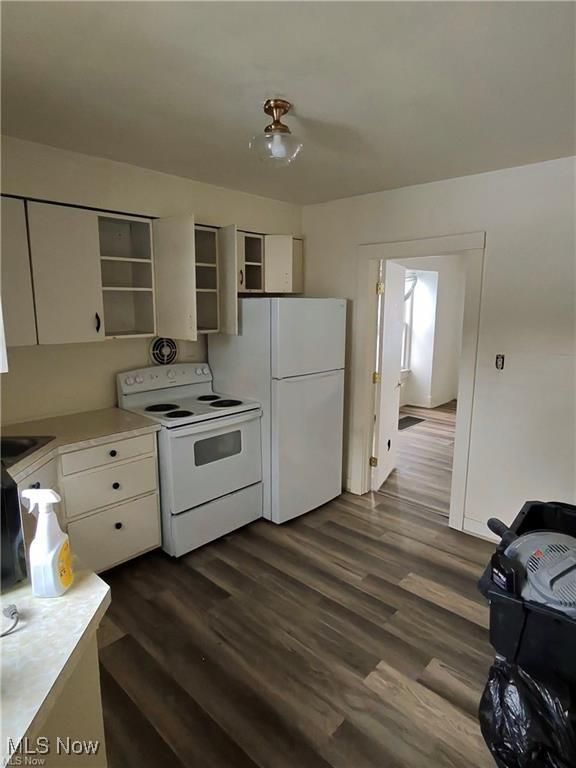 kitchen with white cabinetry, white appliances, and dark wood-type flooring