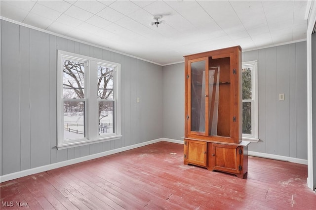 spare room featuring crown molding and light wood-type flooring