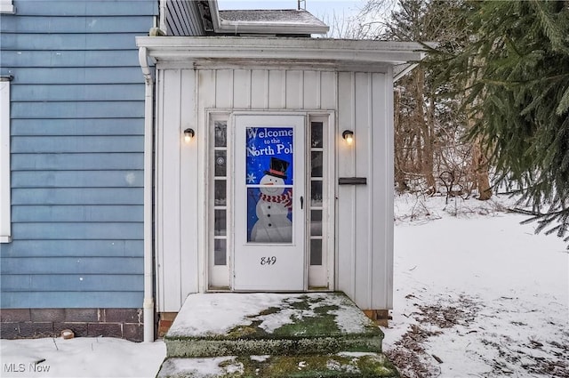 view of snow covered property entrance