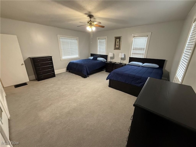 bedroom with ceiling fan and light carpet