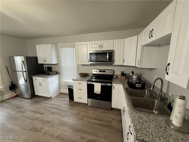 kitchen featuring stainless steel appliances, sink, and white cabinets