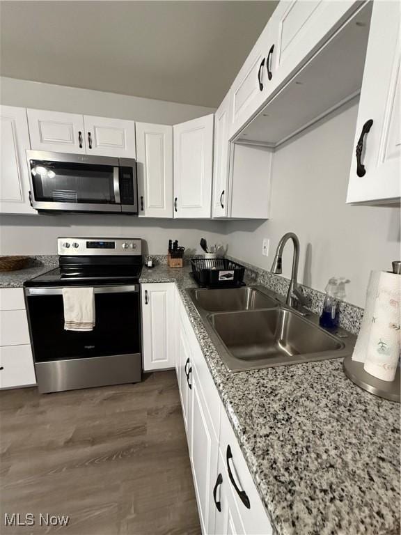 kitchen featuring white cabinetry, sink, dark hardwood / wood-style floors, and appliances with stainless steel finishes