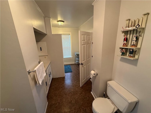 bathroom featuring ornamental molding, vanity, and toilet