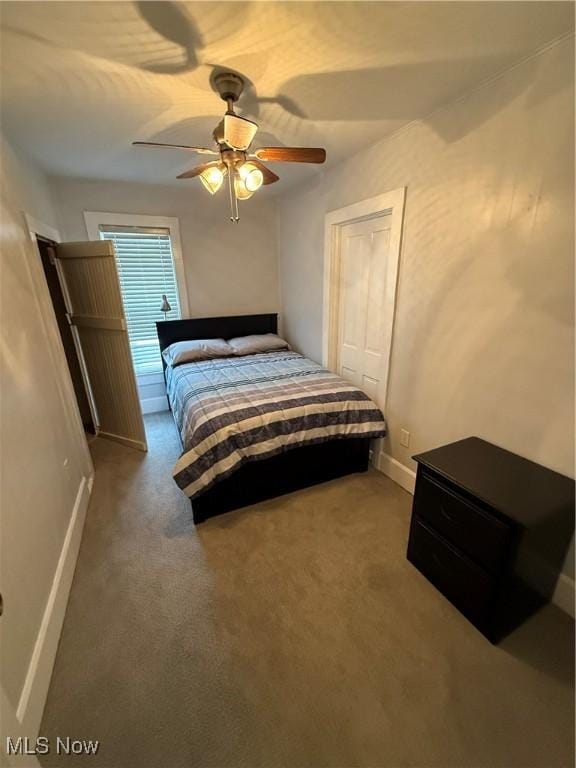 bedroom with carpet flooring, ceiling fan, and a closet