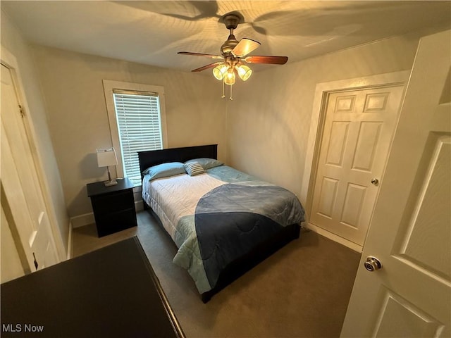 bedroom featuring ceiling fan and dark colored carpet