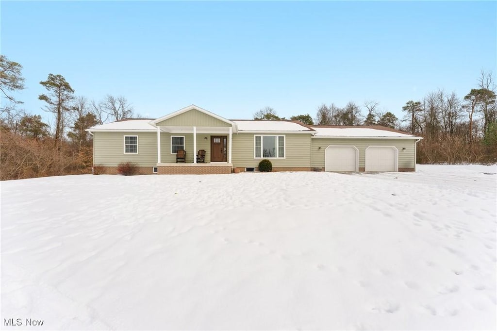 single story home featuring a garage and covered porch