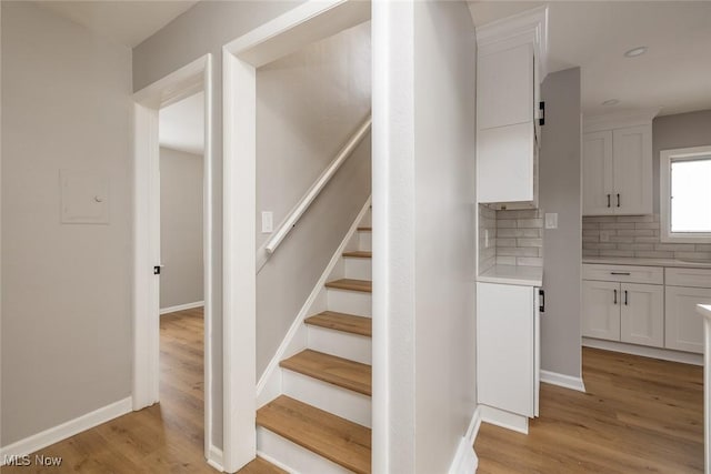 stairway featuring wood-type flooring