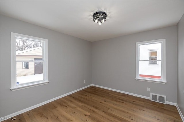 spare room with hardwood / wood-style floors